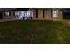 A home's front yard at night with grass, a trailer, and an American flag at 1675 Eden Ct, Clearwater, FL 33756