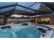 Inviting hot tub under screened-in enclosure, perfect for relaxation and enjoying the outdoors at 1675 Eden Ct, Clearwater, FL 33756