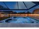 Inviting hot tub with spa with lights and fence in backyard at 1675 Eden Ct, Clearwater, FL 33756