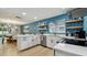 Well-lit kitchen with stainless steel appliances, white cabinets and adjacent dining area at 1675 Eden Ct, Clearwater, FL 33756