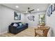 Cozy living room featuring a comfortable blue sofa and coastal-themed decor at 1675 Eden Ct, Clearwater, FL 33756