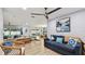 Open-concept living room with beachy decor, wood floors, and lots of natural light at 1675 Eden Ct, Clearwater, FL 33756