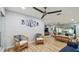 Open living area with stylish rattan chairs, wood floors, and comfortable seating at 1675 Eden Ct, Clearwater, FL 33756