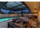 Spacious outdoor living area includes a pool, seating, and dining, all enclosed for comfort and privacy at 1675 Eden Ct, Clearwater, FL 33756