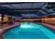 Inviting screened-in pool area with in-ground pool, spa and covered seating area at 1675 Eden Ct, Clearwater, FL 33756