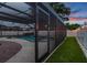 Screened-in pool enclosure includes a putting green for added outdoor enjoyment at 1675 Eden Ct, Clearwater, FL 33756