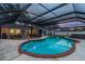 Sparkling pool with brick trim under screened-in enclosure, an ideal backyard retreat at 1675 Eden Ct, Clearwater, FL 33756