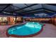 Inviting screened-in pool area with in-ground pool, spa and patio space at 1675 Eden Ct, Clearwater, FL 33756