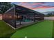 Backyard features a putting green within a screened enclosure, perfect for outdoor activities at 1675 Eden Ct, Clearwater, FL 33756