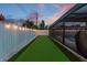 A side yard putting green with lights along the fence adds recreational charm to the property at 1675 Eden Ct, Clearwater, FL 33756