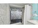 Bathroom boasting a luxurious tiled shower with an outdoor view, natural rock wall, and upscale shower fixtures at 1675 Eden Ct, Clearwater, FL 33756