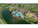 Aerial view of the community clubhouse, pool, lake, and recreational facilities at 18033 Foxtail Loop, Venice, FL 34293