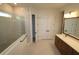 Bathroom with a glass enclosed shower, double sink vanity with marble countertops, and white cabinets at 18033 Foxtail Loop, Venice, FL 34293