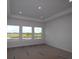 Bright bedroom featuring recessed lighting, a tray ceiling, and three windows offering a pool view at 18033 Foxtail Loop, Venice, FL 34293