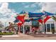 Outdoor market or shopping area with colorful sunshades, brick-paved ground, and lively pedestrian traffic at 18033 Foxtail Loop, Venice, FL 34293