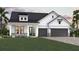 Charming two-story home featuring a two-car garage, landscaped front yard and a stone-accented facade at 18033 Foxtail Loop, Venice, FL 34293