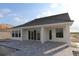 Back of home features a pool, a gray tile patio, and sliding glass doors at 18033 Foxtail Loop, Venice, FL 34293