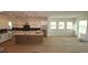 Open concept kitchen with white cabinets, a large island, and modern appliances at 18033 Foxtail Loop, Venice, FL 34293