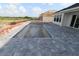 In-ground pool features a modern design with a large gray brick patio surrounding it at 18033 Foxtail Loop, Venice, FL 34293