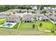Aerial shot of a residence showcasing its well-manicured lawn, adjacent to a tranquil lake at 1821 Cherry Walk Rd, Lutz, FL 33558