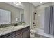Bathroom showing a vanity with granite countertop and adjacent shower-tub combination at 1821 Cherry Walk Rd, Lutz, FL 33558