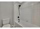 Bathroom showcasing a white tiled bathtub with a sleek, modern matte black shower fixture at 1821 Cherry Walk Rd, Lutz, FL 33558