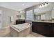Bathroom showcasing a soaking tub, walk-in shower, and double vanity sinks at 1821 Cherry Walk Rd, Lutz, FL 33558