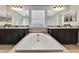 A luxurious bathroom with a soaking tub and double vanity sinks at 1821 Cherry Walk Rd, Lutz, FL 33558