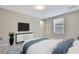 Bedroom with a TV, window, and plush carpet for added comfort and style at 1821 Cherry Walk Rd, Lutz, FL 33558