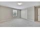 Inviting bedroom with a soft carpet, natural light from the window, and a convenient closet at 1821 Cherry Walk Rd, Lutz, FL 33558