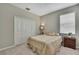 Comfortable carpeted bedroom features a bed, closet, and bedside table for a cozy retreat at 1821 Cherry Walk Rd, Lutz, FL 33558