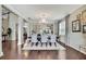 Charming dining room with chandelier, hardwood floors, and view into other living spaces at 1821 Cherry Walk Rd, Lutz, FL 33558