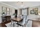 Elegant dining room with chandelier, hardwood floors, large table, and tasteful decor at 1821 Cherry Walk Rd, Lutz, FL 33558
