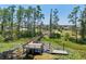 Tranquil lake with lily pads with a wooden dock, offering a serene spot for relaxation and nature appreciation at 1821 Cherry Walk Rd, Lutz, FL 33558