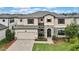 Charming two-story home featuring a stone archway, well-kept landscaping, and a two-car garage at 1821 Cherry Walk Rd, Lutz, FL 33558