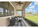 Covered lanai featuring outdoor seating with a ceiling fan and a view of the backyard at 1821 Cherry Walk Rd, Lutz, FL 33558
