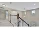 Bright foyer with hardwood floors and white staircase with decorative chandelier at 1821 Cherry Walk Rd, Lutz, FL 33558