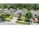 Aerial view of a single-Gathering home with well-manicured landscaping, a screened pool, and a two-car garage at 18343 Waydale Loop, Hudson, FL 34667