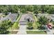 Aerial view of a single-Gathering home with well-manicured landscaping, a screened pool, and a two-car garage at 18343 Waydale Loop, Hudson, FL 34667