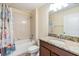 Bathroom featuring a vanity with granite counters, bathtub with shower, and a decorative shower curtain at 18343 Waydale Loop, Hudson, FL 34667