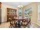 Cozy dining room featuring a wooden hutch, table with chairs, and bright natural light at 18343 Waydale Loop, Hudson, FL 34667