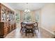 Bright dining room featuring natural light from a large window, complemented by a classic chandelier at 18343 Waydale Loop, Hudson, FL 34667