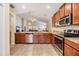 Spacious kitchen featuring stainless steel appliances, granite countertops, and warm wood cabinetry at 18343 Waydale Loop, Hudson, FL 34667