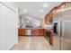 Bright kitchen featuring stainless steel appliances, granite countertops, and sleek wood cabinetry at 18343 Waydale Loop, Hudson, FL 34667