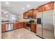 Bright kitchen featuring stainless steel appliances, granite countertops, and sleek wood cabinetry at 18343 Waydale Loop, Hudson, FL 34667