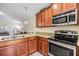 Bright kitchen featuring stainless steel appliances, granite countertops, and sleek wood cabinetry at 18343 Waydale Loop, Hudson, FL 34667