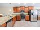 Bright kitchen featuring stainless steel appliances, granite countertops, and sleek wood cabinetry at 18343 Waydale Loop, Hudson, FL 34667