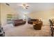 Bright living room featuring comfortable seating, a ceiling fan, and access to an outdoor patio at 18343 Waydale Loop, Hudson, FL 34667