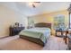 Serene main bedroom featuring a large bed, dresser, and plenty of natural light at 18343 Waydale Loop, Hudson, FL 34667