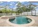 Inviting screened-in pool and spa area with brick pavers, perfect for relaxation and entertainment at 18343 Waydale Loop, Hudson, FL 34667